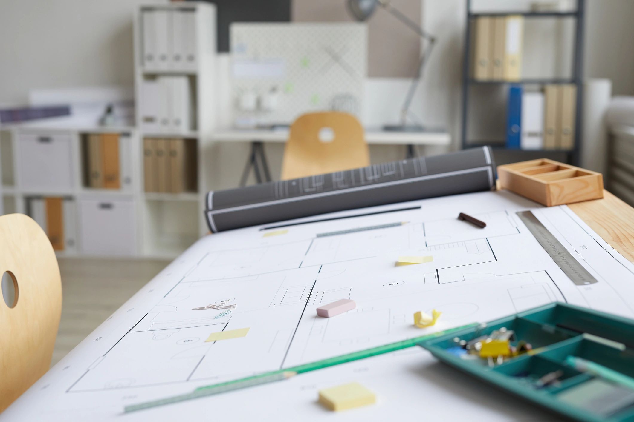 Architect workspace with blueprints and tools on a drafting table