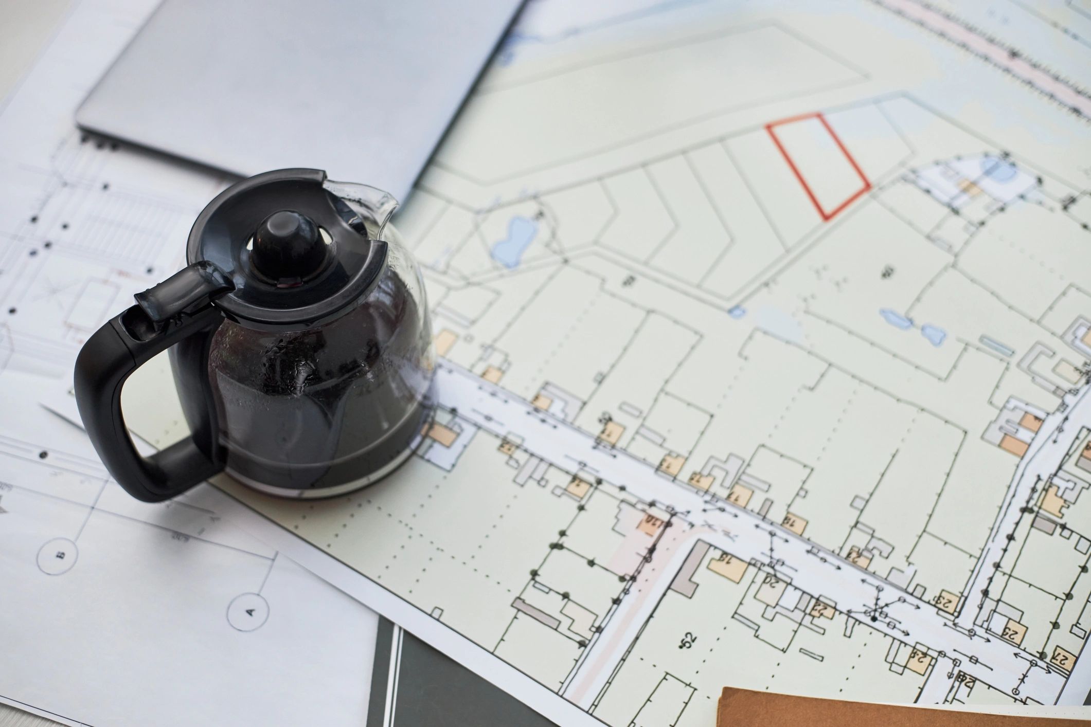 Architectural planning documents and blueprints on a desk